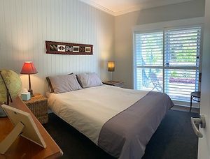 This was our bedroom. It was very cozy and comfortable. My favourite features were the ceiling fan and the glass door leading to a garden seating area with a lovely hanging chair. at The Beet Retreat in Cooroibah