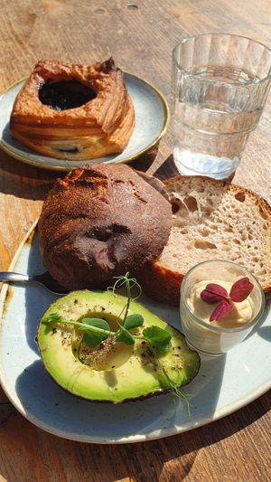 Blueberry volcano and sourdough bun with avocado at Kaf in Copenhagen