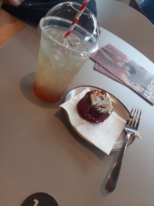 Vegan cake and iced peach tea. at Phoenix Cafe Bar in Leicester