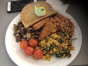 Full sized vegan breakfast with scrambled tofu, mushrooms, tomatoes, hash browns, beans and toast with spread at Phoenix Cafe Bar in Leicester