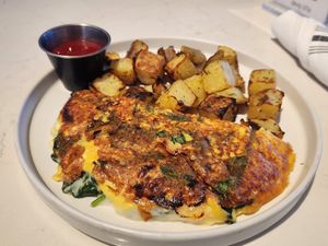 Greek omelet with fried potatoes at Love Life Cafe in Miami