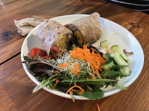 Cuban burrito (whole wheat wrap, black bean sofrito, lettuce, organic basmati brown rice, sweet plantains , tomatoes, avocado, cilantro aioli sauce, served with salad) at Love Life Cafe in Miami