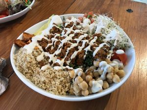 Taco salad (kale salad, lentil walnut "meat", organic quinoa, garbanzo beans, cherry tomatoes, alfalfa sprouts, pico de gallo, avocado, tortilla chips, cashew cream, lemon dressing at Love Life Cafe in Miami