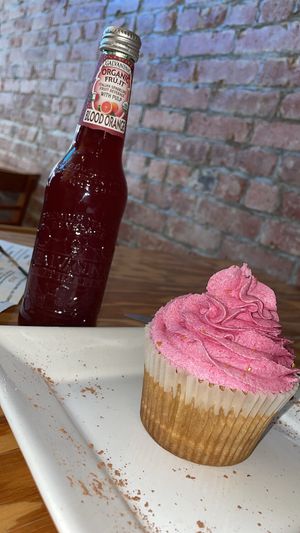 pink vanilla cupcake and blood orange soda   at Right Path Organic Cafe in New London