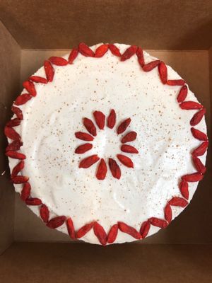 A blurry shot of a whole raw carrot goji berry cake ordered for a special event. at Right Path Organic Cafe in New London