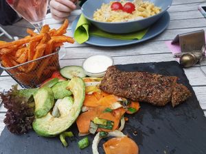 The steak with avocado, veg and sweet potato fries. The carbonara in back. at Veggiezz - Am Salzgriess in Vienna