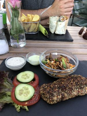 Seitan steak with vegetables and gyro wrap! 10/10 recommend the steak but would choose a different side next time! at Veggiezz - Am Salzgriess in Vienna