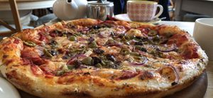 Vegan olive & red onion stonebaked pizza  at The Veggie Cafe in Ilkley