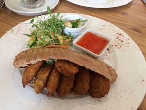 Falafel pita, served with small, fresh salad, houmous and sweet chilli sauce. at The Veggie Cafe in Ilkley