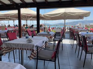 Large restaurant with outdoor seating at Romeo Pizza in Volos
