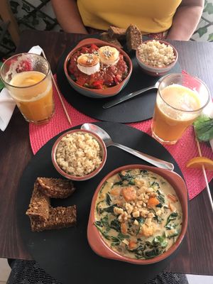 Spanish Pisto up top (vegetarian) and a Squash & Spinach soup (vegan) in front of me. Both delicious. at Dona Flor Cafe in Cascais