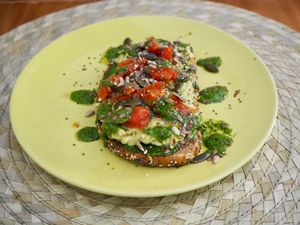 Tostada de aguacate, tomate cherry  y pesto at Dona Flor Cafe in Cascais