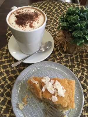 Coconut cake with Hot chocolate  at Dona Flor Cafe in Cascais