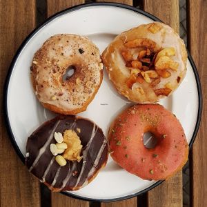 Salted caramel hazelnut donut, maple smoked coconut donut, strawberry pistachio donut, chocolate peanutbutter donut at Brammibal's Donuts - Maybachufer in Berlin