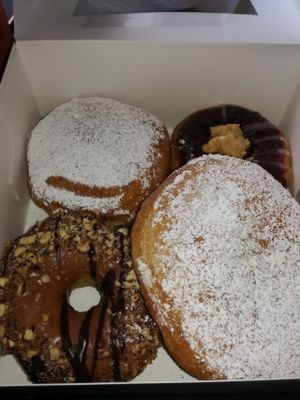Donuts. One with chocolate and peanutbutter fudge, one with nougat and two filled with dulce de leche (weekly special). at Brammibal's Donuts - Maybachufer in Berlin
