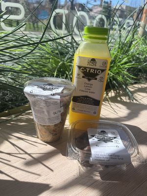 Salad cup, peanut butter date truffles, and cold pressed juice from the fridge  at Green Point Juicery in Verona