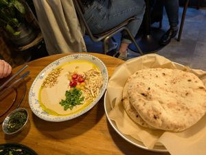 Hummus and pita with zhug at La Hummuseria in Madrid