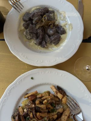 Purple gnocchi at top.  Mushroom/seitan or potato cake at bottomm  at Mezzaluna in Turin
