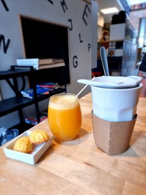 fresh juice and tea - note side cookies not vegan at Books & Brunch in Bruges