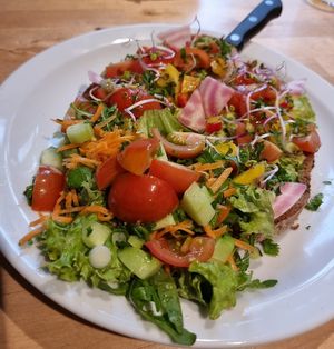 toast with mashed avocado and vegetables at Books & Brunch in Bruges