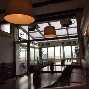 View of porch seating from the indoor seating room. at Yak Tibetaans Restaurant in Oostende