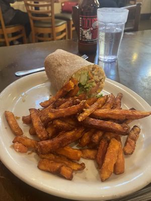 Burrito (other half already eaten) with sweet potato fries  at East West Cafe in Santa Rosa