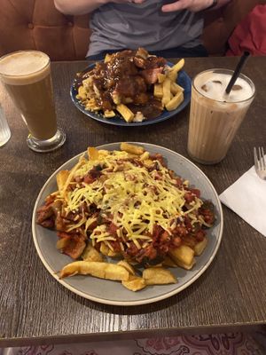 Vegan bolognaise and chips with an oat iced latte   at Maggie Mays in Belfast