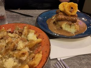 Curry chip and champ + vegan sausage + champ + onion rings + peppercorn sauce at Maggie Mays in Belfast