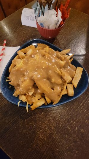 Vegan cheesy chip with curry sauce. at Maggie Mays in Belfast