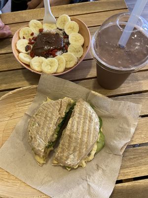Oatmeal with extra chocolate peanut butter, panini with avocado and hummus and a smoothie with cacao, dates, peanut butter and banana at Milk Away in Sevilla