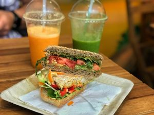 Pesto Arugula & hummus veggie sandwiches, get orangey  & green smile smoothies at Milk Away in Sevilla