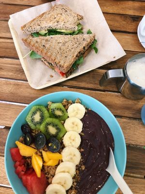 Mixed fruit acai bowl and a rocket, avocado and tomato sandwich!  at Milk Away in Sevilla