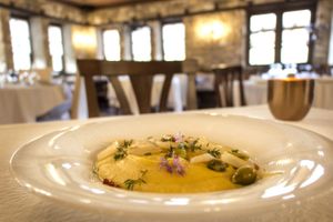 Yellow peas puree with caramelized onions, fresh herbs and pickled green tomatoes from the kitchen garden at Ktima Bellou Restaurant in Pieria