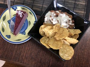 Raw chili w cashew sour cream & corn chips w a slice of raspberry cheesecake  at Raw Balance Raw Food Deli in Taupo