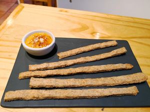 This snack comes for free first, it's some whole - grain crackers with a delicious puree that tastes most like carrot and pumpkin - vegan. at Zen Tea in San Martin De Los Andes