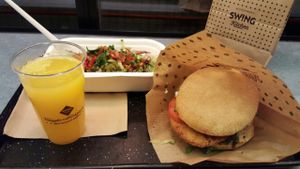 Burger with a side of salad and freshly squeezed oj at Swing Kitchen - Operngasse in Vienna