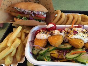 Schnitzel burger, fries, onion rings and nugget salad at Swing Kitchen - Operngasse in Vienna