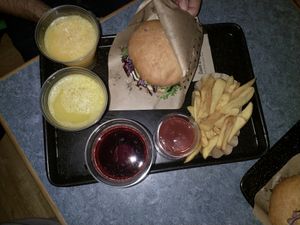Cheeseburger, fresh orange juice, fries, organice ketchup and cherry juice. at Swing Kitchen - Operngasse in Vienna