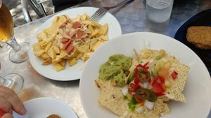 Nachos and Potatoes with vegan bacon at Ruta 42 in Lhospitalet De Llobregat