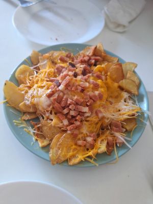 Media racion de patatas con bacon y queso. at Ruta 42 in Lhospitalet De Llobregat