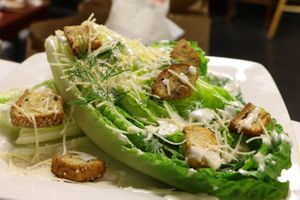 701 Caesar Salad with gf house-made croutons, parmesan cheese, dill sprig, and grilled buddha meat at 701 Coffee in Seattle