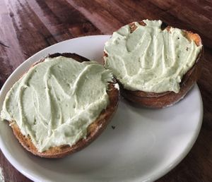 Artisan bagel with Raw Chive/Onion Cashew Spread made in-house. 100% Vegan at 701 Coffee in Seattle