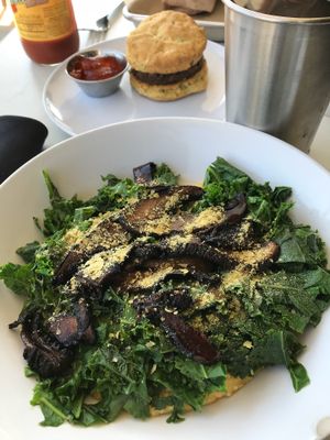 Yummy breakfast of kale and cheese grits!  Breakfast is served all day! at Gnome Cafe in Charleston