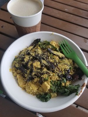 Cheezy grits with tofu scramble, kale, and mushroom bacon at Gnome Cafe in Charleston