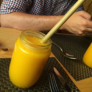 fresh mango juice with their famous bamboo straws  at Jalus Vegan Kitchen in Hanoi
