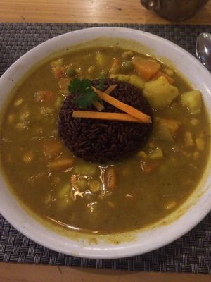 Spicy potato curry with red rice at Jalus Vegan Kitchen in Hanoi