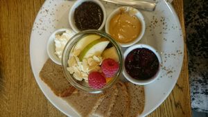 sweet plate with cream cheese, homemade nutella, peanutbutter, fruit preserves, fresh fruit, cinnamon and bread  at Wesola Cafe in Krakow