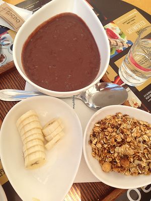 acai bowl with acai smoothie, homemade granola and fresh banana at cacao in Prague