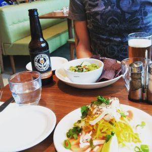 Super spicy ?coconut papaya chili lime raw vegan salad, guacamole with blue corn chips and this Goldeneye Pale Ale for him. at Mildreds - Camden in North West London