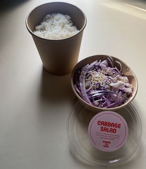 rice bowl with no sauce and cabbage salad  at Knees to Chin in Brussels